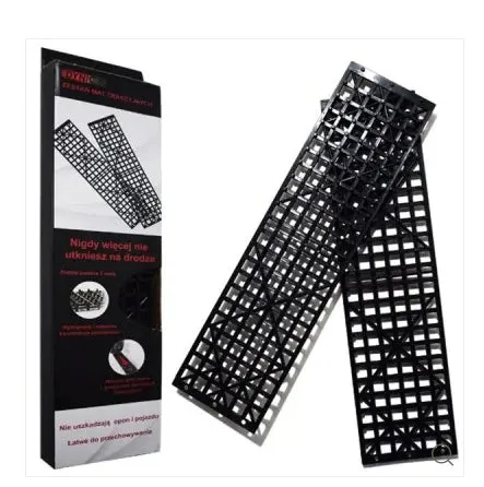 Pair of black rubber car recovery plates on a muddy ground, each 55×15 cm, for self-rescue from soft terrain
