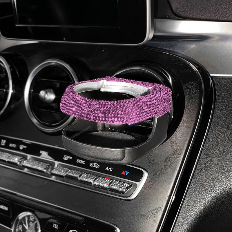 White diamond-decorated car cup holder bracket clipped onto a vehicle air vent.