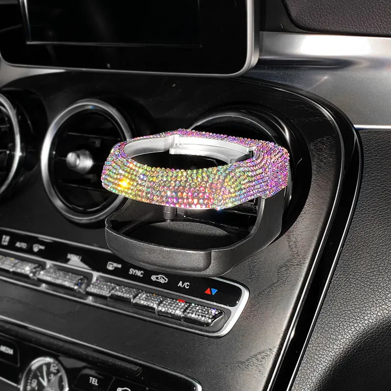 White diamond-decorated car cup holder bracket clipped onto a vehicle air vent.