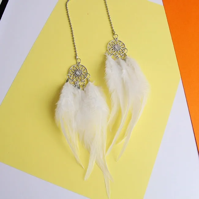 Dreamcatcher car ornament with metal frame and feather in one of six colours on car interior