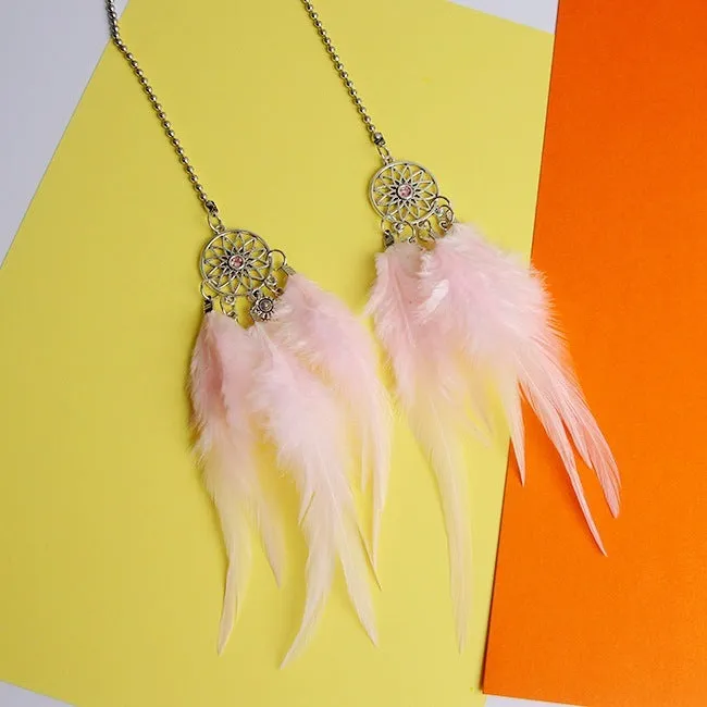 Dreamcatcher car ornament with metal frame and feather in one of six colours on car interior