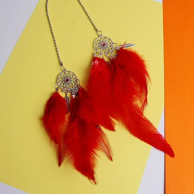 Dreamcatcher car ornament with metal frame and feather in one of six colours on car interior