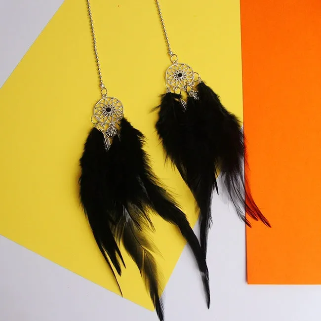 Dreamcatcher car ornament with metal frame and feather in one of six colours on car interior