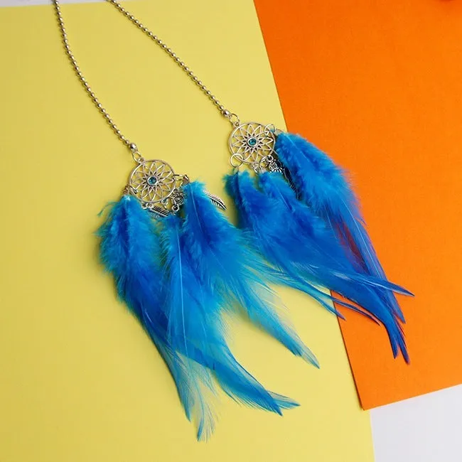 Dreamcatcher car ornament with metal frame and feather in one of six colours on car interior