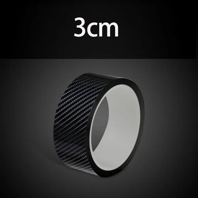 Black carbon fiber self-adhesive anti-collision decorative strip roll for car door threshold and bumper edge protection.