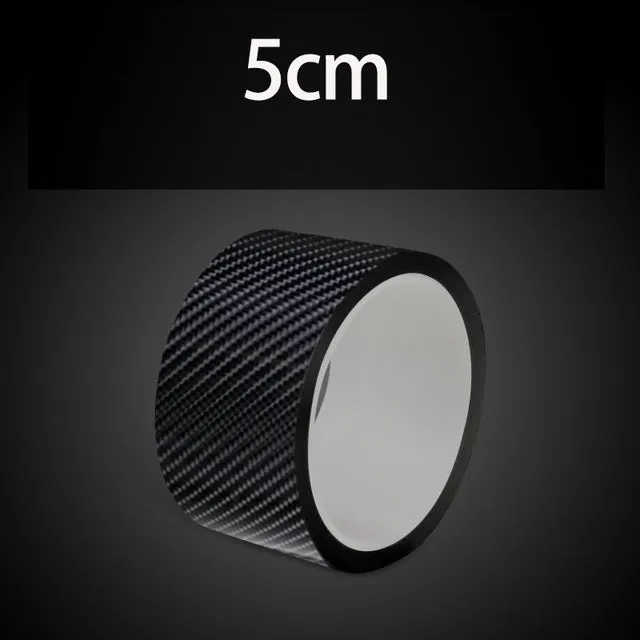 Black carbon fiber self-adhesive anti-collision decorative strip roll for car door threshold and bumper edge protection.