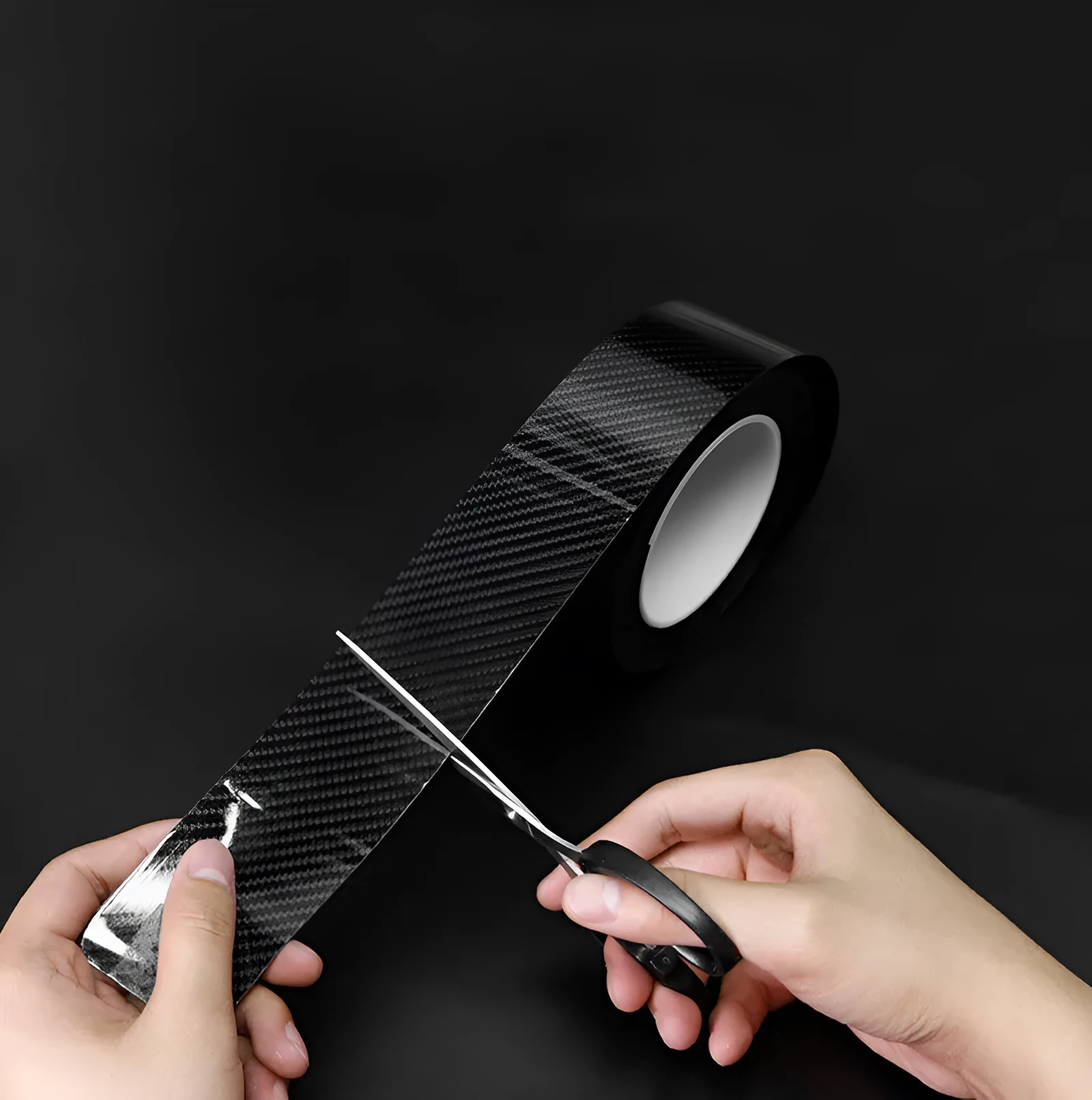 Black carbon fiber self-adhesive anti-collision decorative strip roll for car door threshold and bumper edge protection.