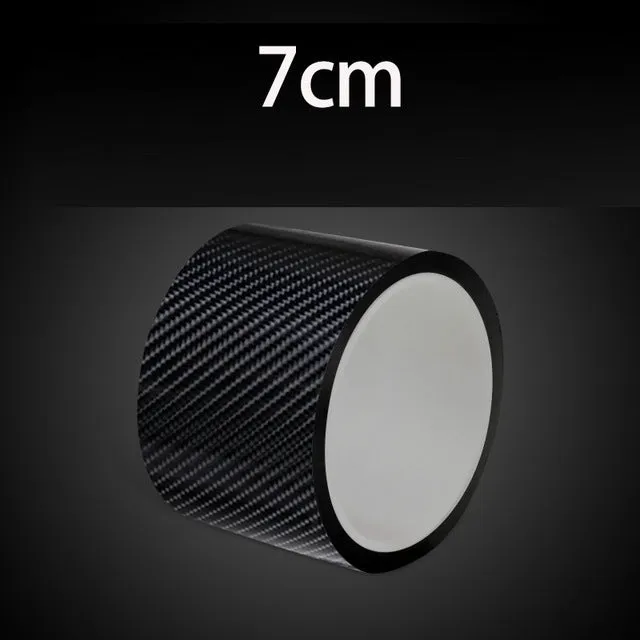 Black carbon fiber self-adhesive anti-collision decorative strip roll for car door threshold and bumper edge protection.