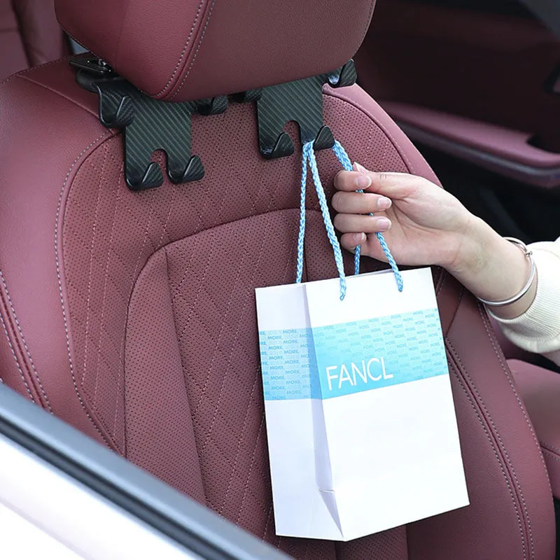 Black ABS plastic car hook and mobile phone holder bracket for rear seat back storage.
