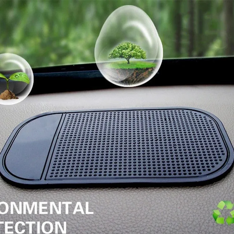 Black silicone car anti slip mat with spider-web texture, 13x7cm, on a car dashboard holding a smartphone