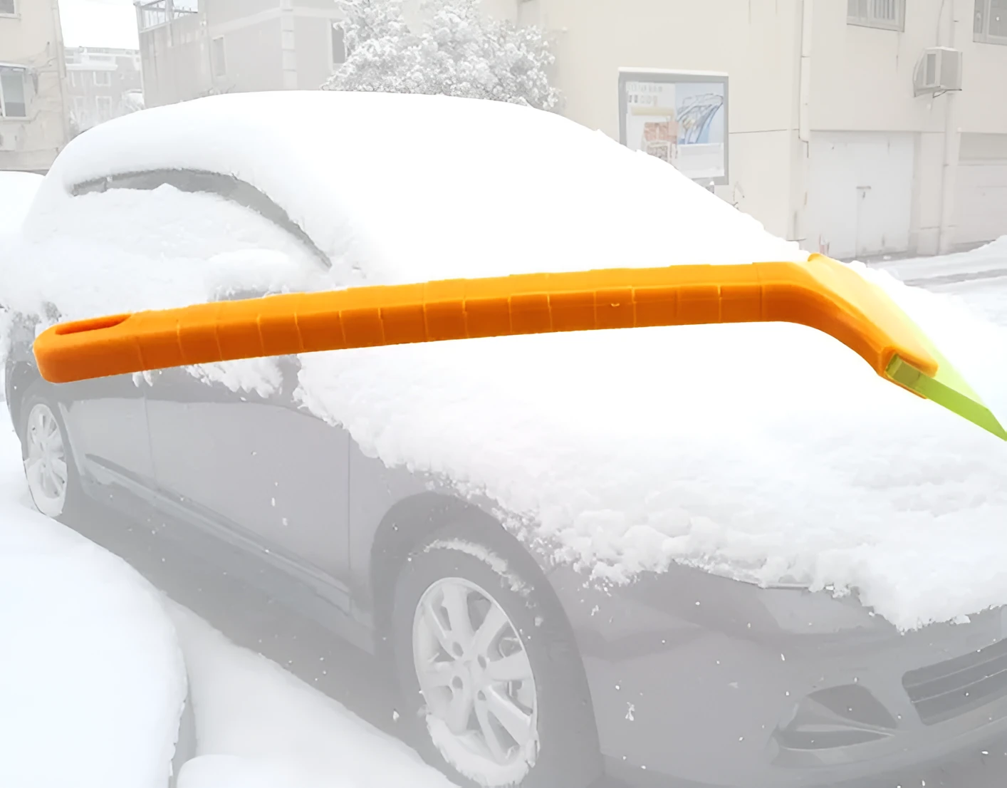 Yellow plastic car snow shovel for ice removal, 32cm length, on a dark background