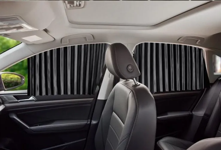 Magnetic car curtain sun shade in black attached to vehicle side window