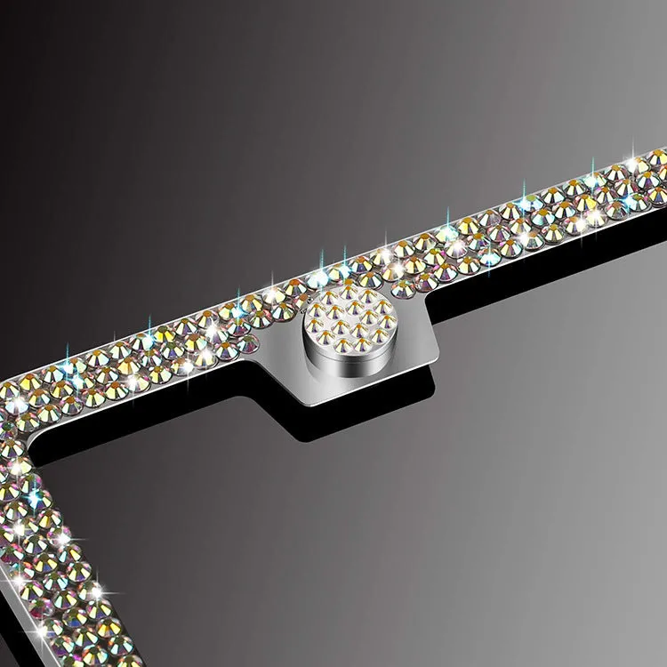 White diamond-studded stainless steel licence plate frame on a car showing 160x310mm external size