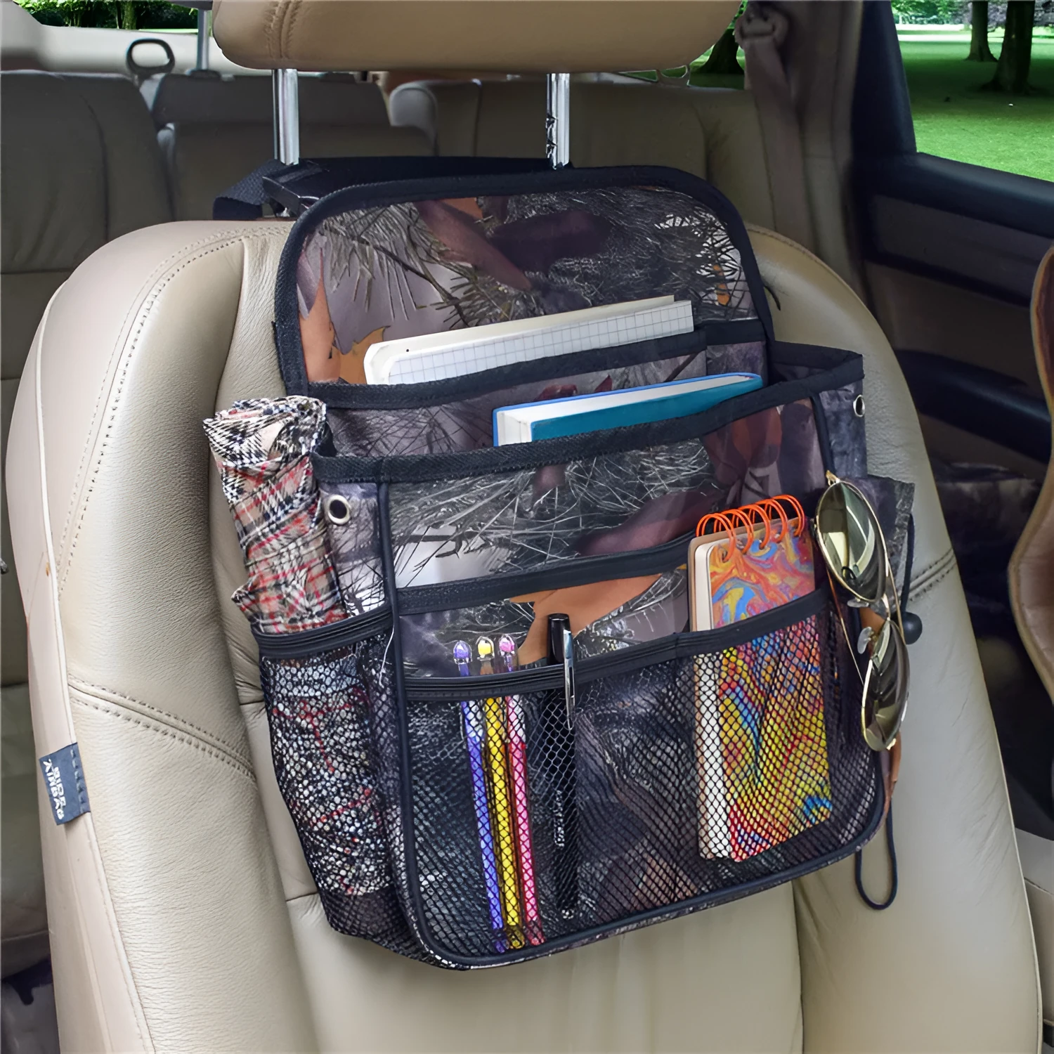 Black polyester car suspension storage bag with 35x28x9cm dimensions, hanging behind a car seat
