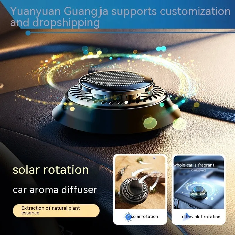 Black solar-powered car air freshener with rotating double rings on car dashboard