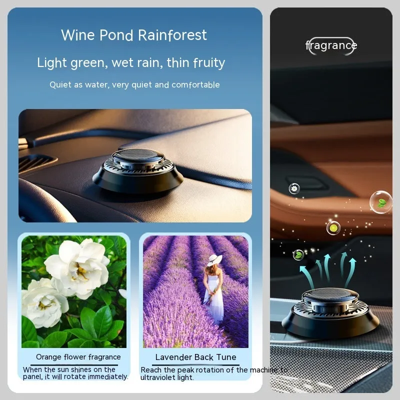 Black solar-powered car air freshener with rotating double rings on car dashboard