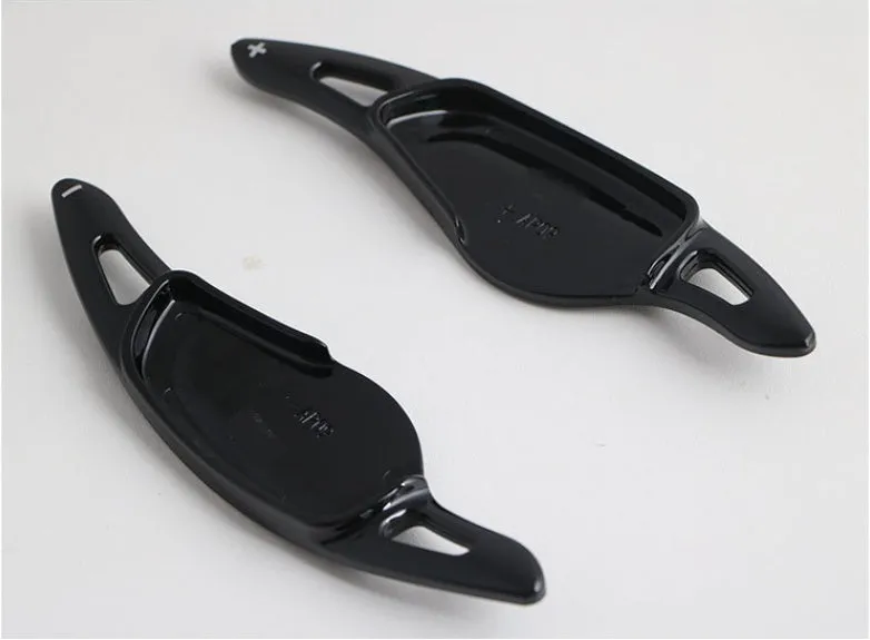 Steering wheel paddle shifters in carbon fibre black finish for manual gear control enhancement