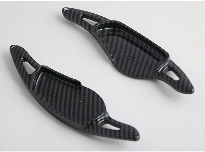 Steering wheel paddle shifters in carbon fibre black finish for manual gear control enhancement