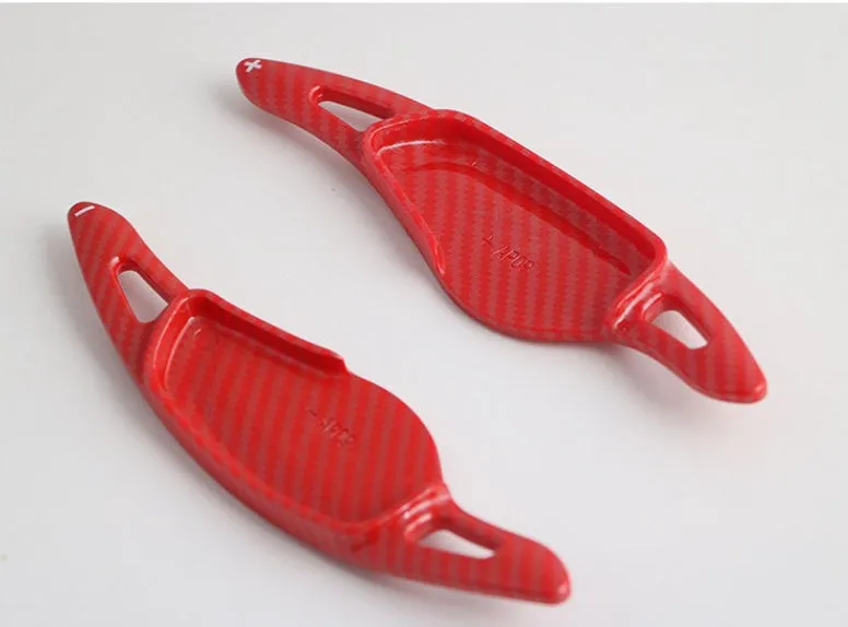 Steering wheel paddle shifters in carbon fibre black finish for manual gear control enhancement