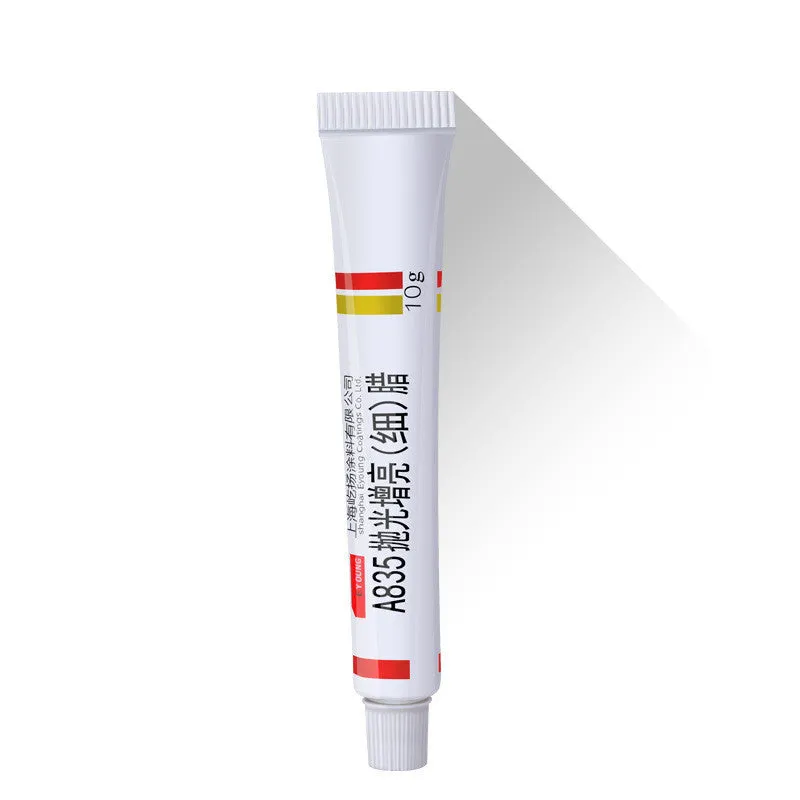 Car scratch repair kit with polishing wax, sandpaper, sponge, cloth, scraper, and brush on workbench