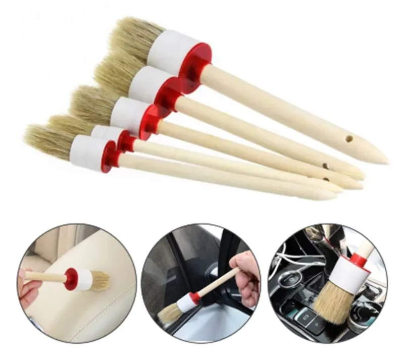 Round head car washing brush with pig bristles and wooden handle on a workbench