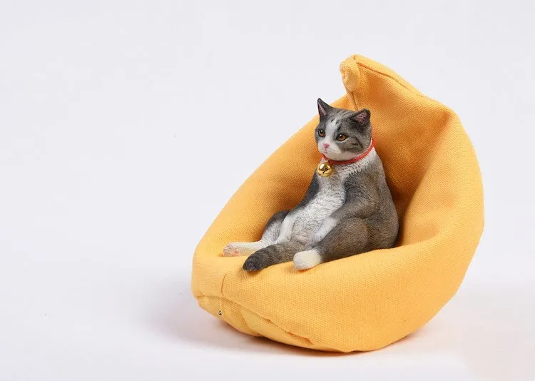 Small lazy cat car ornament with fabric sofa, 75mm high dashboard decoration.