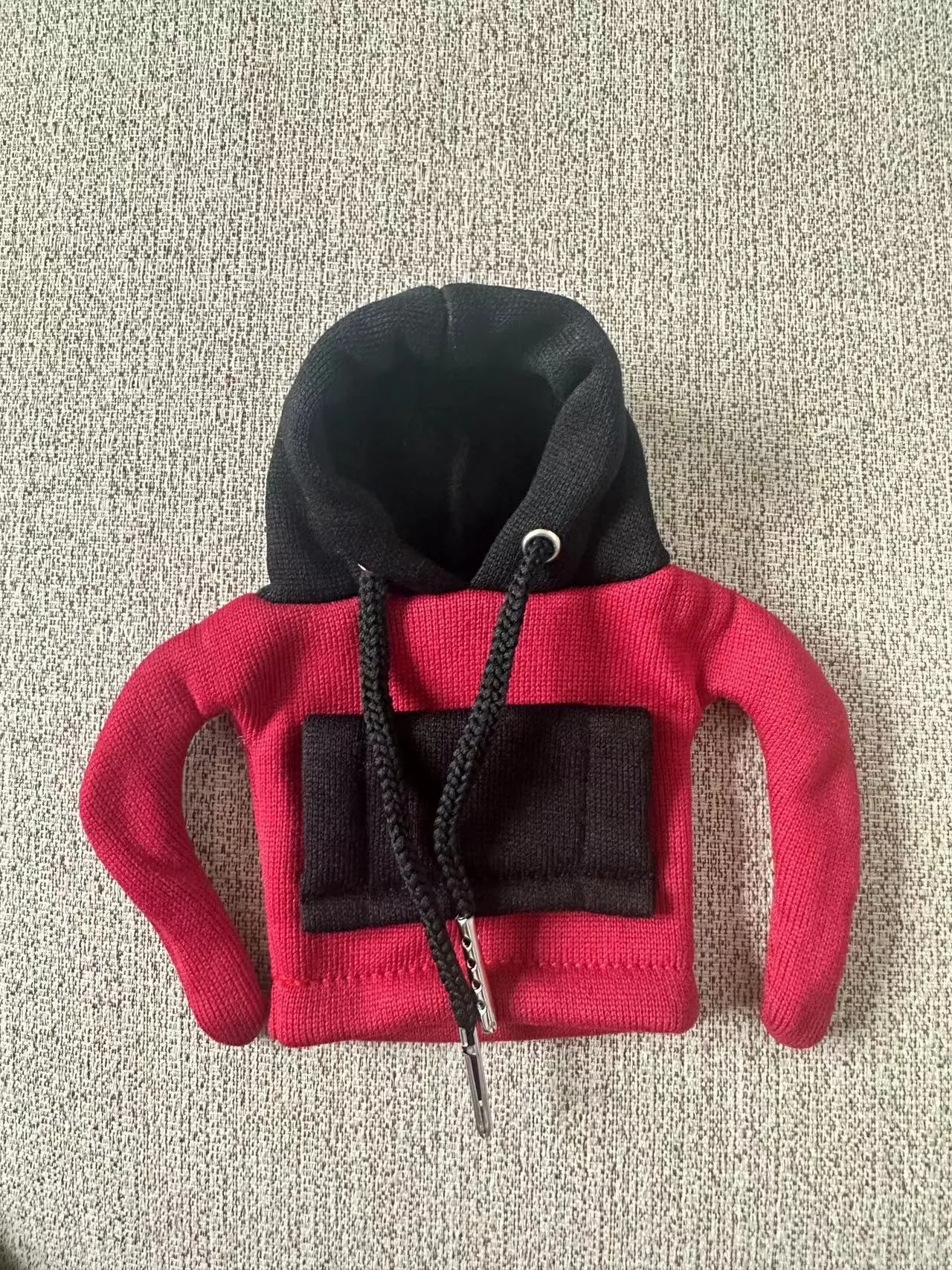 Polyester knit hood cover for car gear lever in red and white colour combination.