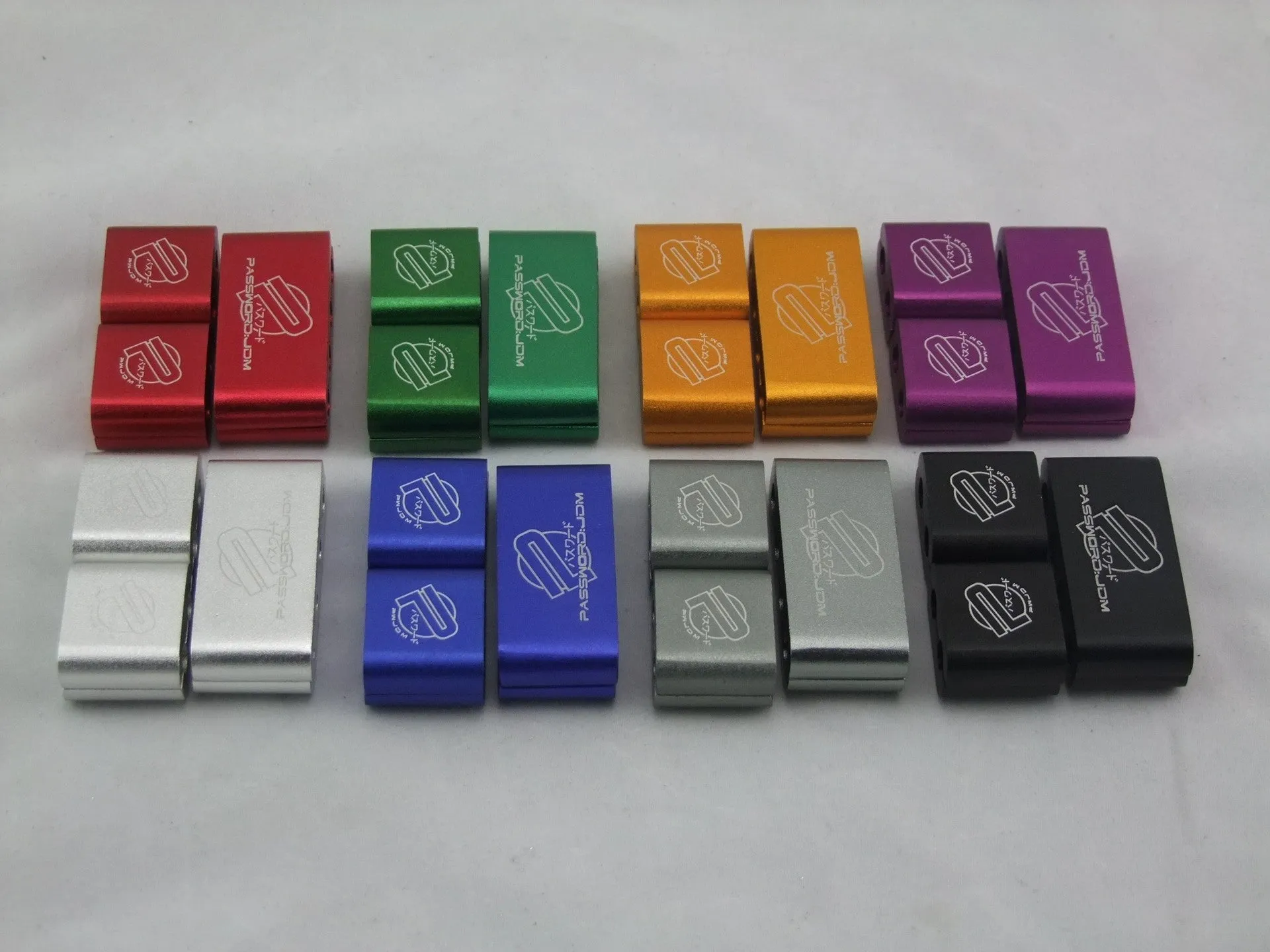 Set of three metal car modification fastening clamps with a fixed sleeve in assorted colours.