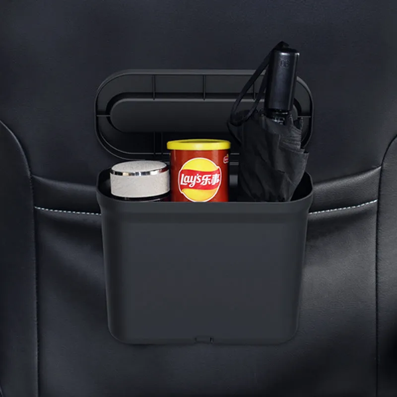 Black 1.7L PP plastic car trash can suspended on centre console with lid open, interior visible