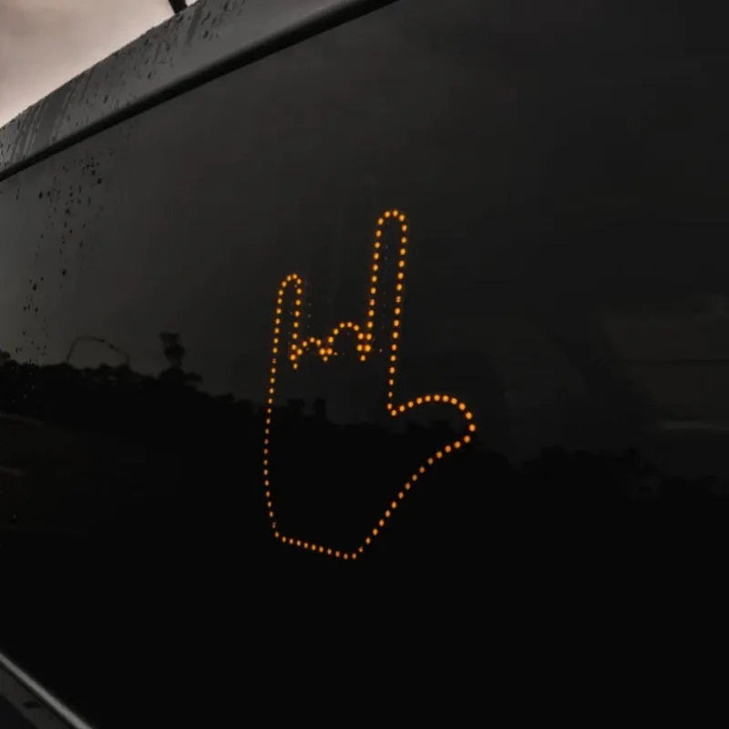 Black LED gesture car light with amber illumination showing hand gesture, remote control, and 3M Velcro mounting