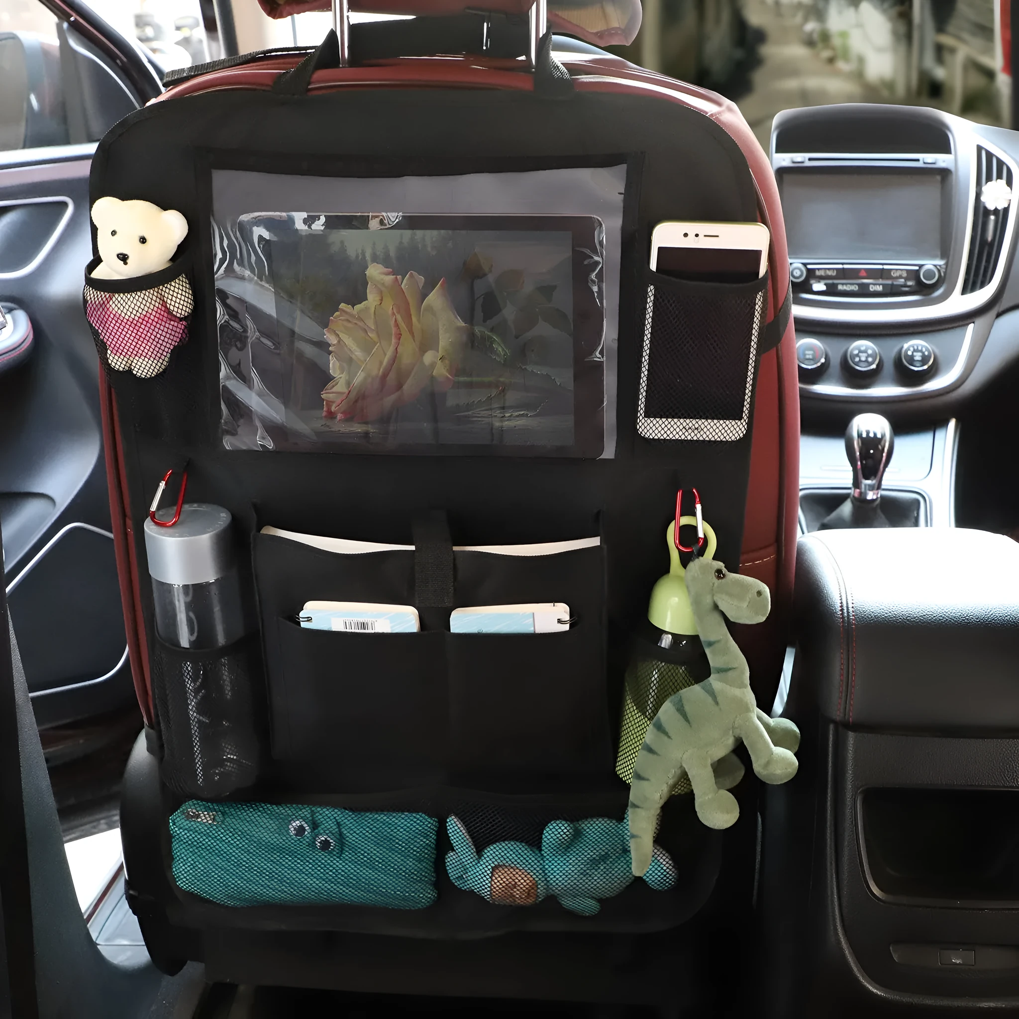 Black multi-pocket car organiser hanging on back seat headrest with phone and drink holders