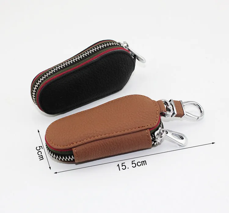 Brown leather car universal key case holding a car key on a white background