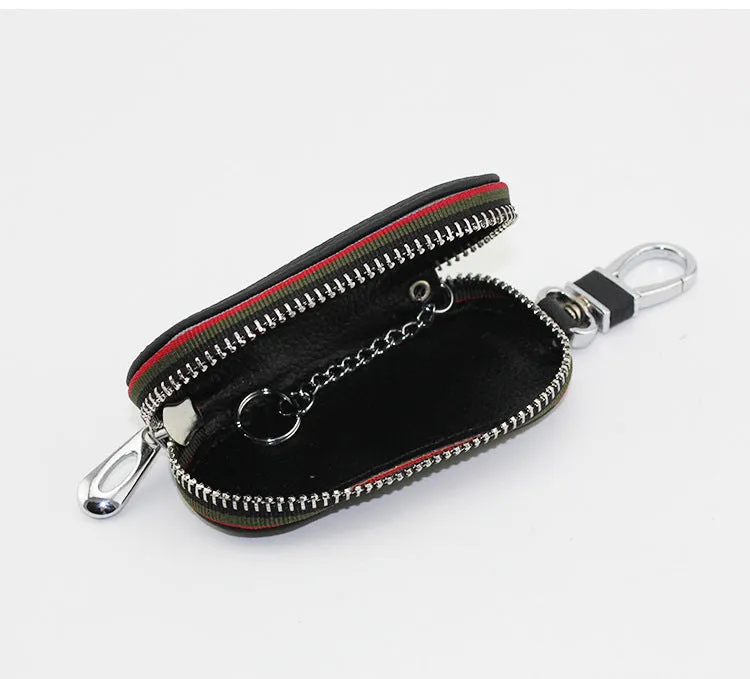 Brown leather car universal key case holding a car key on a white background