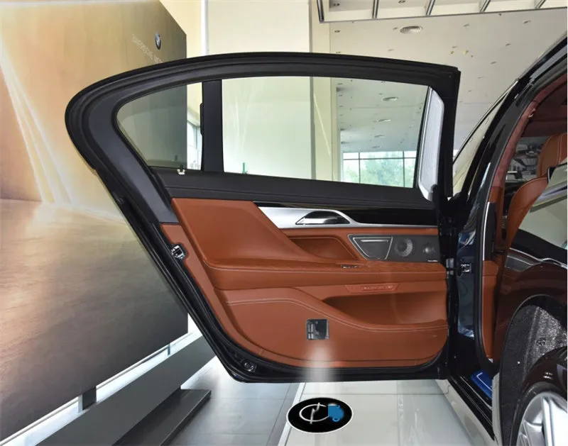 Two black wireless car LED welcome door projection laser lights showing a 3D logo projected onto the ground