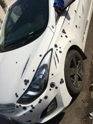 Car scratch simulation bullet hole crack vinyl sticker 21x30cm with four hole pattern styles on a car bumper