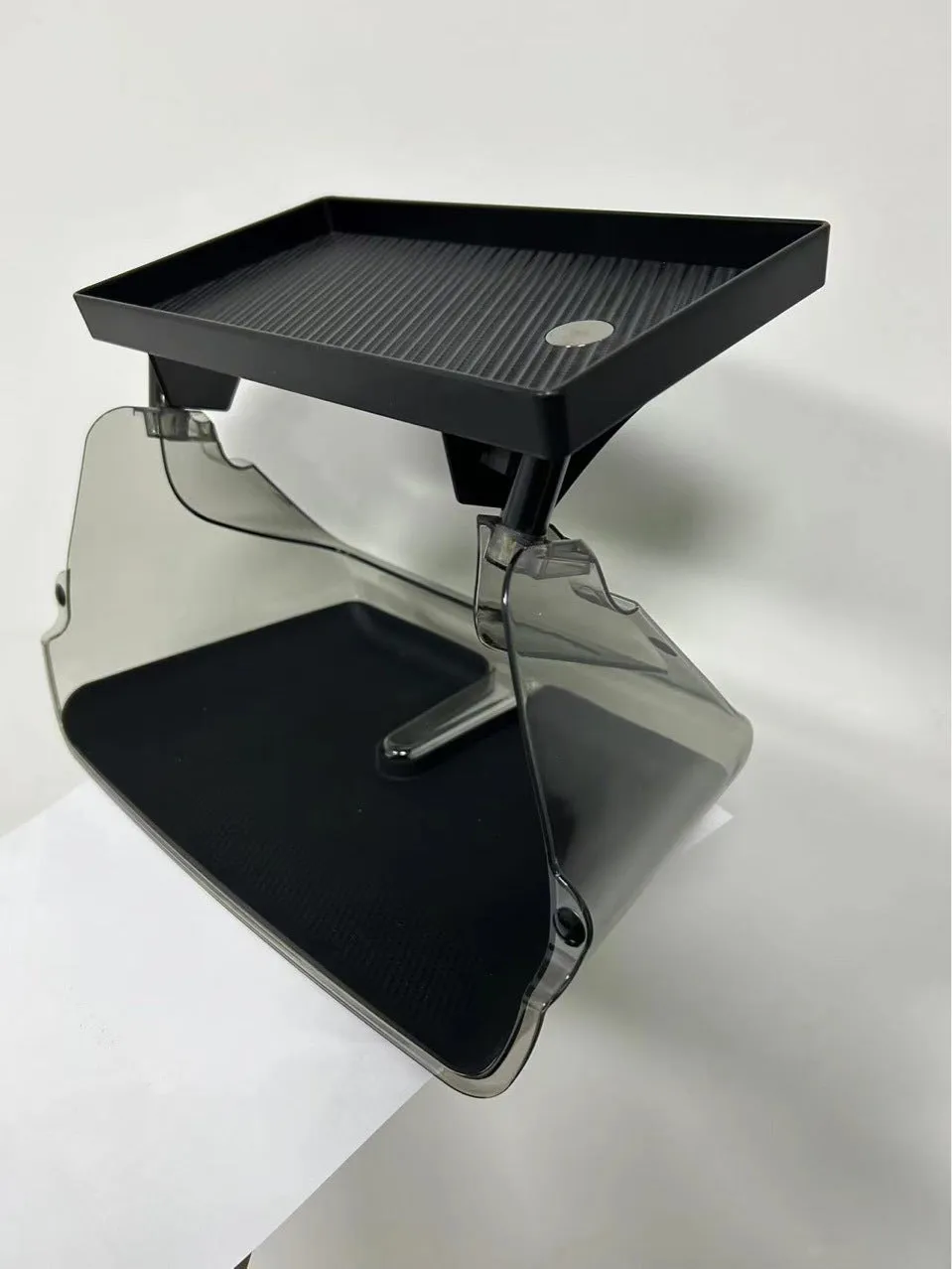 Black ABS plastic storage box fitted under the touchscreen of a Tesla Model Y interior.