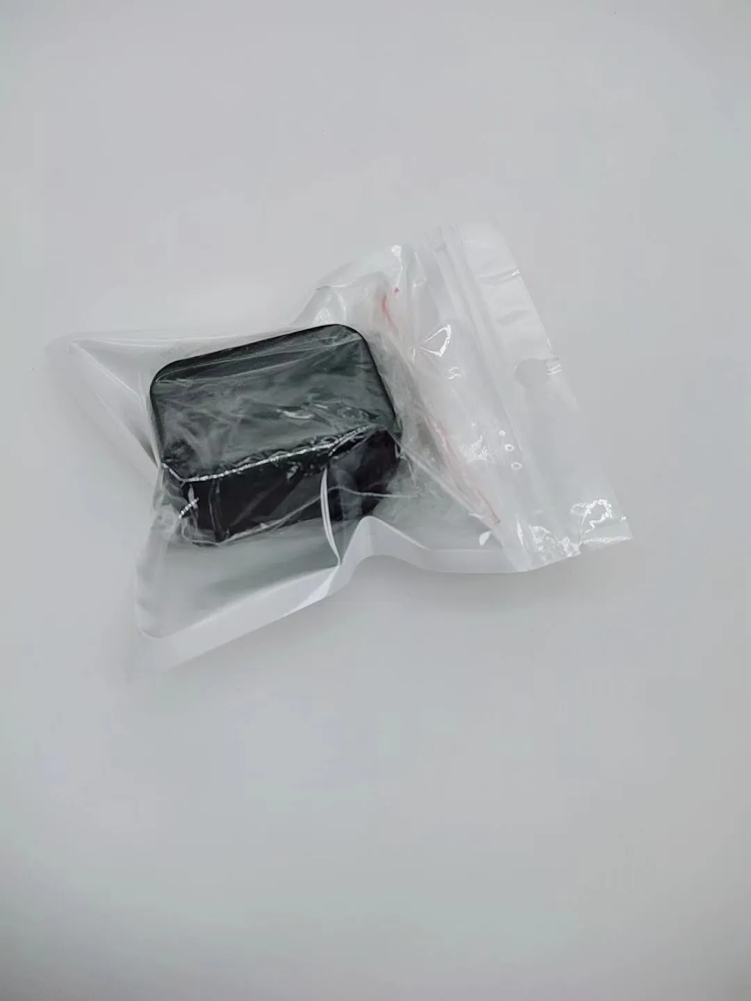 Seat belt buckle protective device in plastic ABS material shown in black and red colour options