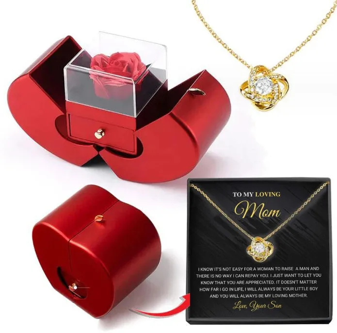 Red apple-shaped jewelry box with eternal soap flower rose and silver necklace inside