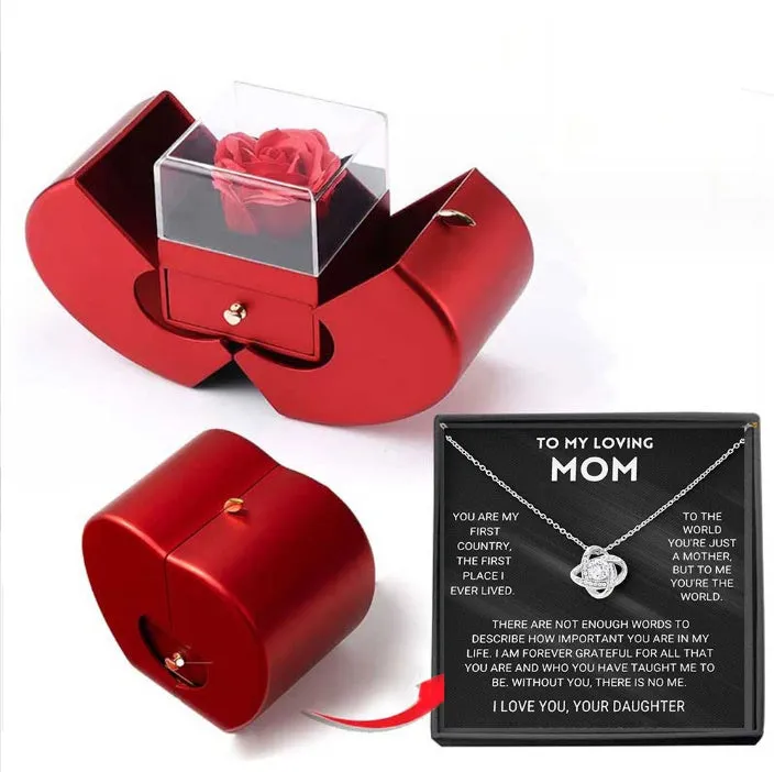 Red apple-shaped jewelry box with eternal soap flower rose and silver necklace inside