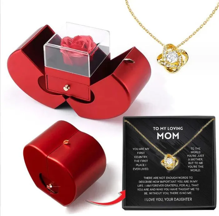 Red apple-shaped jewelry box with eternal soap flower rose and silver necklace inside