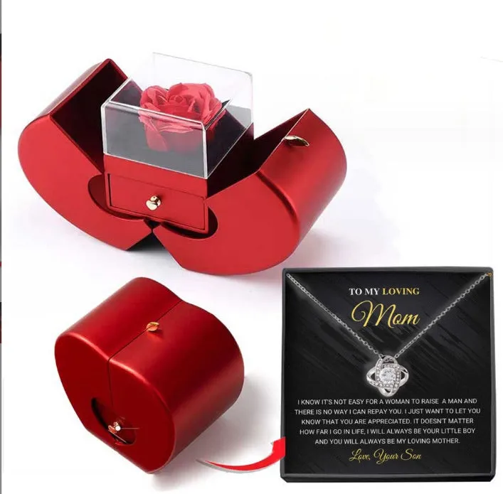 Red apple-shaped jewelry box with eternal soap flower rose and silver necklace inside