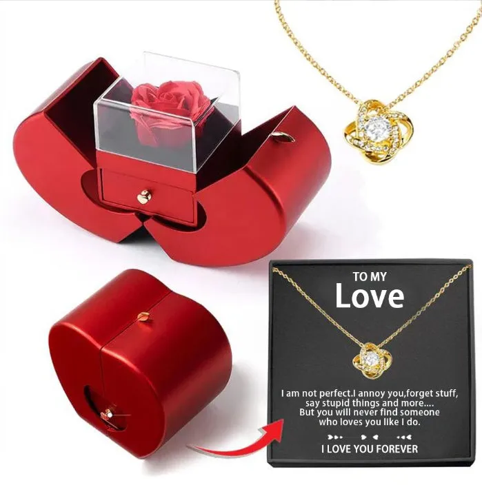 Red apple-shaped jewelry box with eternal soap flower rose and silver necklace inside