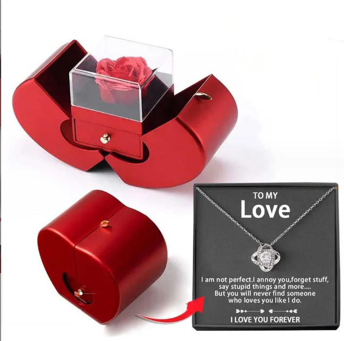 Red apple-shaped jewelry box with eternal soap flower rose and silver necklace inside
