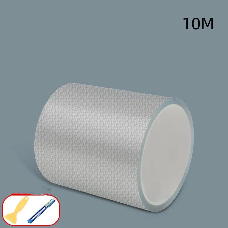 Roll of transparent carbon fibre grain anti-collision strip for car protection with scraper and utility knife.