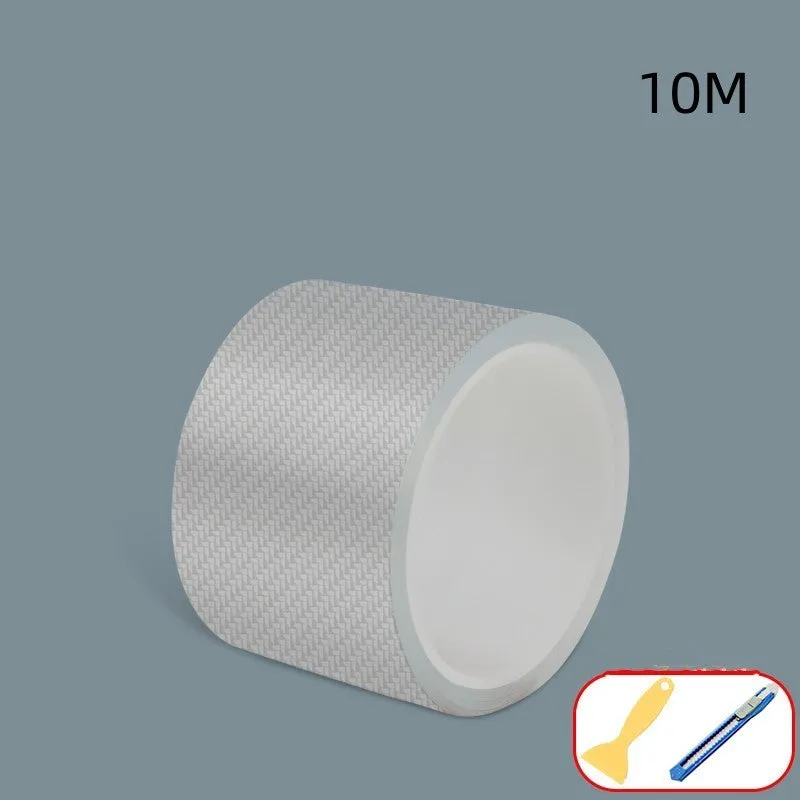 Roll of transparent carbon fibre grain anti-collision strip for car protection with scraper and utility knife.