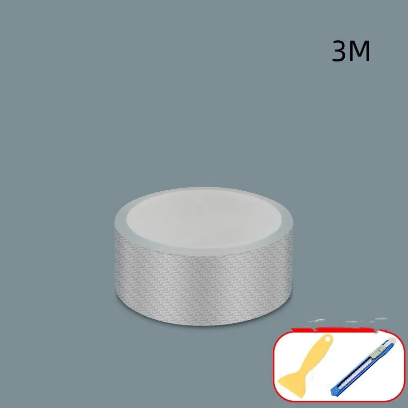 Roll of transparent carbon fibre grain anti-collision strip for car protection with scraper and utility knife.