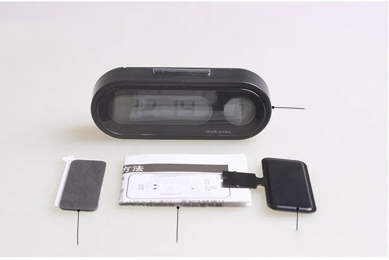 Black electronic car dashboard clock and thermometer with adjustable bracket on display