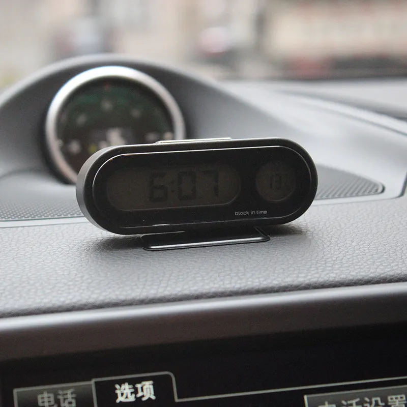 Black electronic car dashboard clock and thermometer with adjustable bracket on display