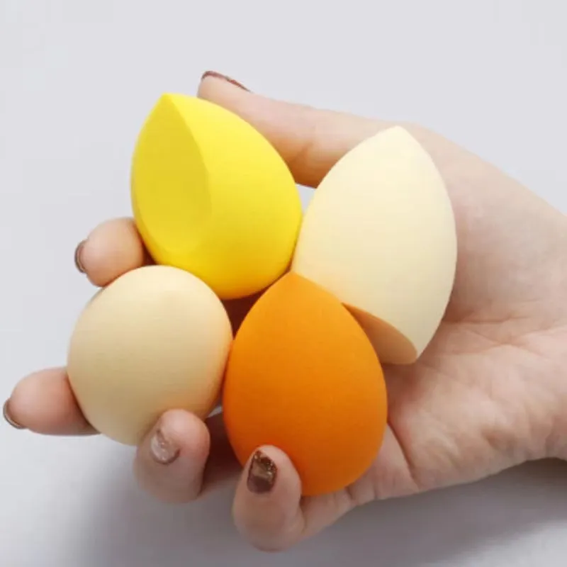 Assorted makeup sponges in seven shapes including pear and peach heart designs, 60x42mm, non-latex material