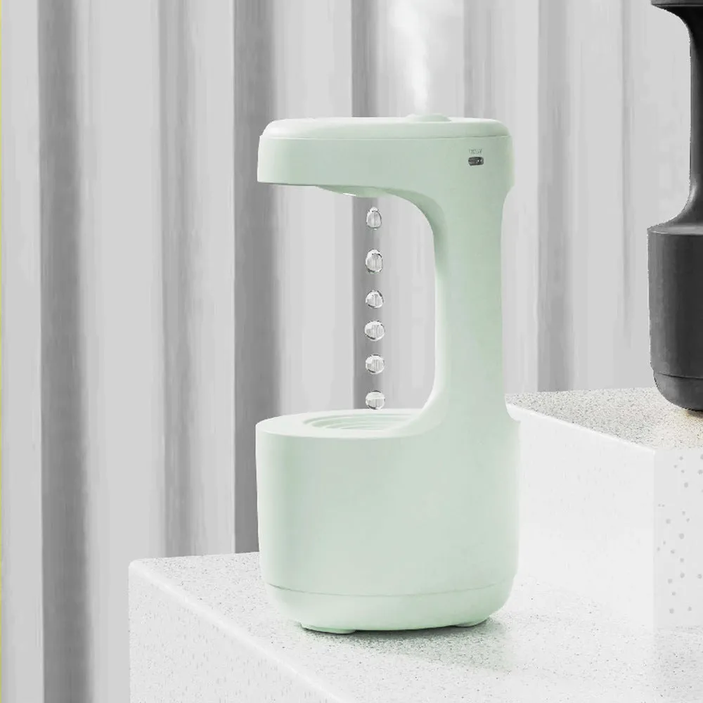 Bedroom anti-gravity humidifier with clock and backflow aroma diffuser in white plastic on desk with LED display